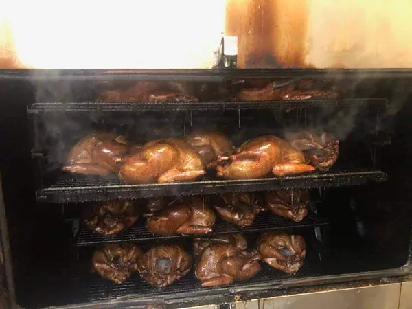 large amounts of food being cooked on smoker