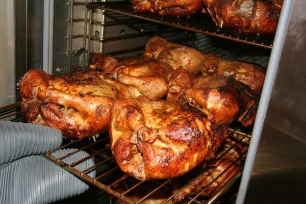 Whole chickens on smoker racks